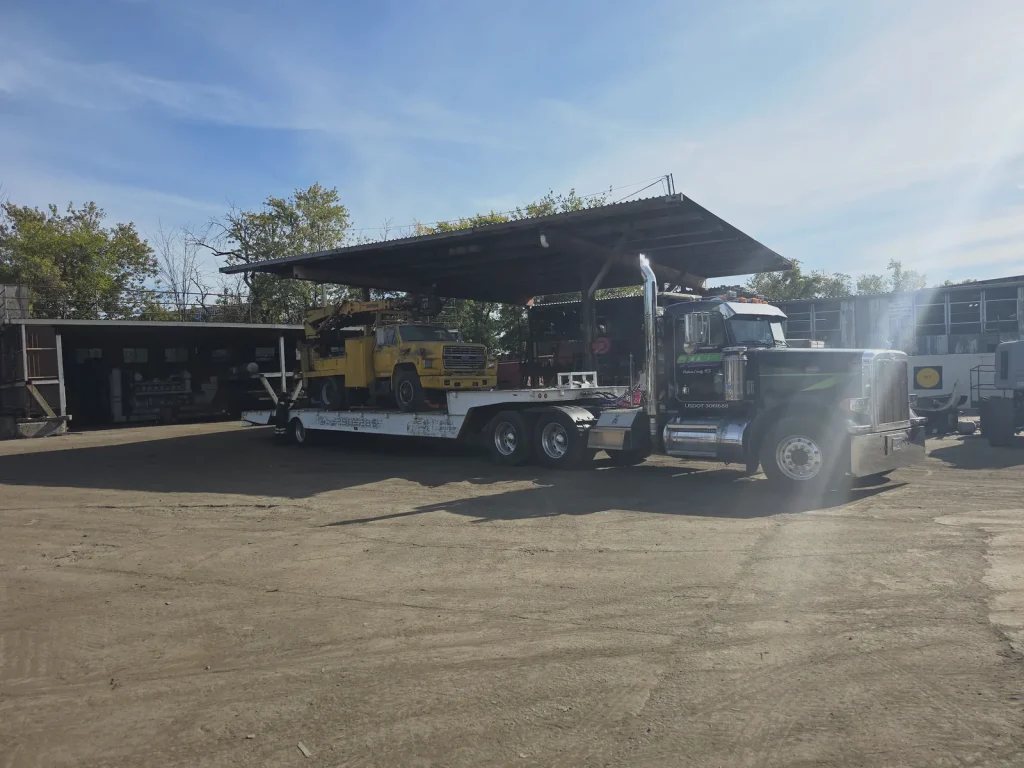 Citywide Automotive heavy-duty Peterbilt hauling a bucket truck on a lowboy trailer in Putnam Valley, NY