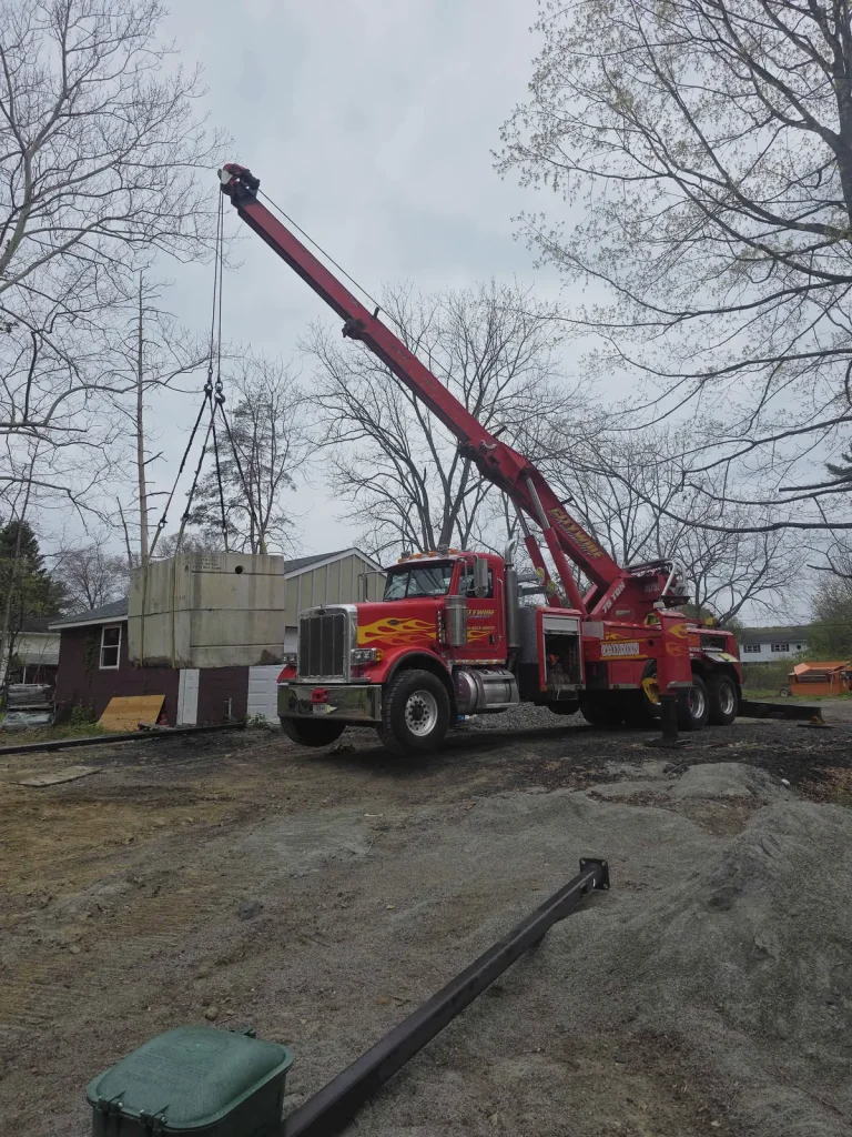 Citywide Automotive red heavy-duty tow truck with boom extended lifting equipment in the Hudson Valley, NY