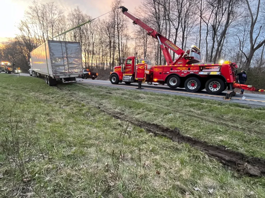 Citywide heavy recovery unit winching a dry van trailer out of a roadside ditch in the Hudson Valley, NY