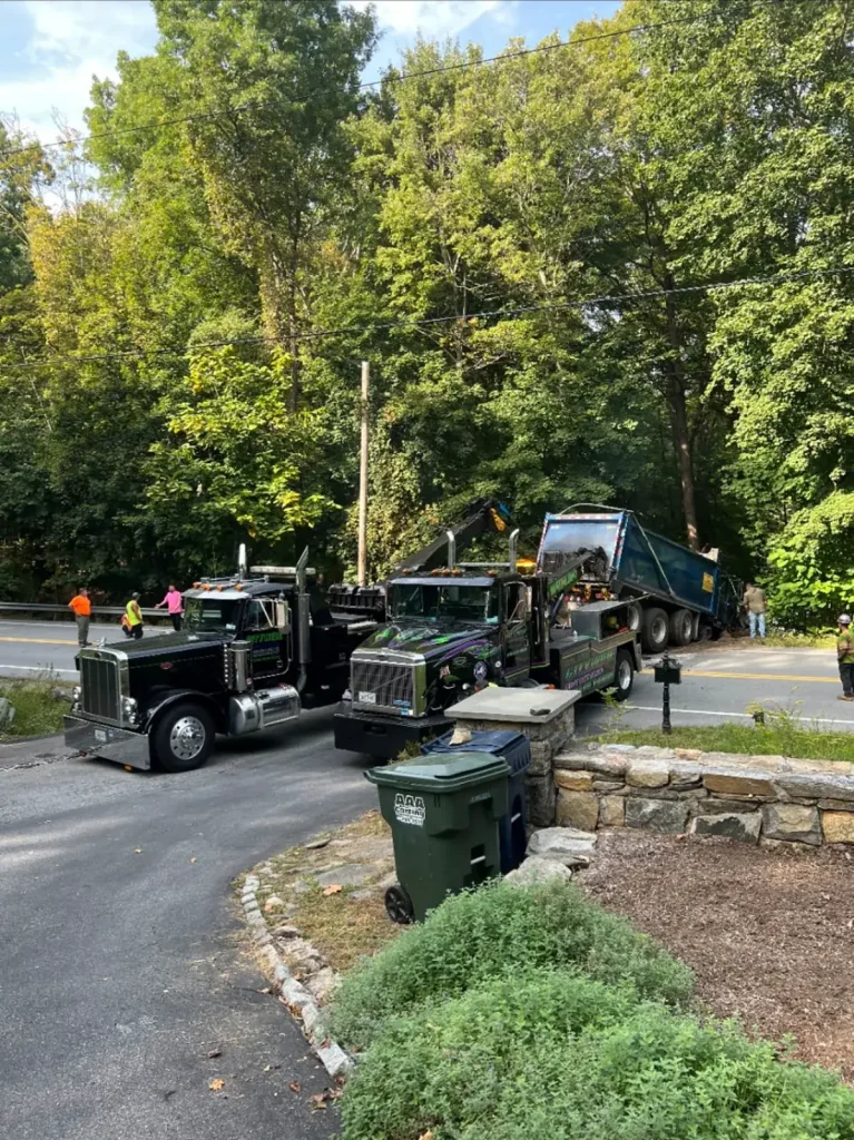 Two Citywide heavy-duty wreckers recovering a dump truck off a wooded road in Putnam Valley, NY